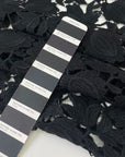 Black lace in wool and polyester with double scallop detail. Soft and elegant, ideal for dresses, skirts, and blouses. High-quality deadstock collected in Stock from a Maison de Couture in Italy.