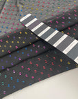 Transparent fil coupé in black background polyester. High-quality deadstock fabric by the meter collected in Stock from a Maison de Couture in Italy.