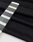 Heavy punto Milano jersey, pure viscose, a little stretch, very flowy in Pirate Black. Ideal for dresses, skirts, and trousers. High-quality deadstock fabric by the meter collected in Stock from a Maison de Couture in Italy.