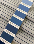 Heavy taffeta in a mix of polyester, silk, and cotton. Gray ground with blue stripes, heavy and stiff. Ideal for structured jackets, dresses, or skirts. High-quality deadstock collected in Stock from a Maison de Couture in Italy.