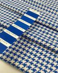 Mixed cotton tweed with a white ground and blue pied de poule pattern, color reference Victoria Blue. Very soft, light, flowy, and not transparent. Ideal for dresses, trousers, skirts, and jackets. High-quality deadstock collected in Stock from a Maison de Couture in Italy.