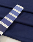 Virgin wool and silk in dark blue, with very small pied de pooule pattern in black. Very light and soft. High-quality deadstock fabric by the meter collected in Stock from a Maison de Couture in Italy.