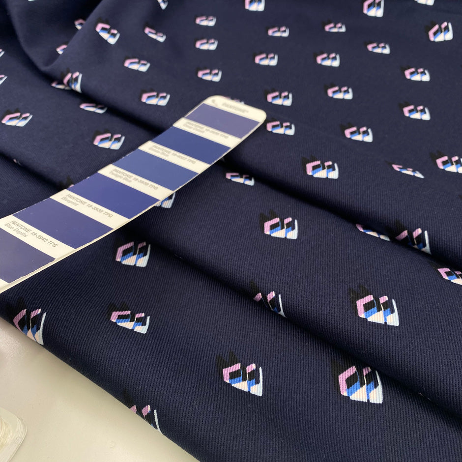 Pure structured and heavy cotton gabardine with dark blue base and geometrical print. Premium deadstock fabric from an Italian Maison de Couture."