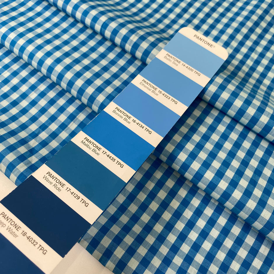 Pure cotton poplin in blue with a small check design (square size approx. half a centimeter). Very soft, light, and not transparent—ideal for shirts, dresses, and skirts. High-quality deadstock collected in Stock from a Maison de Couture in Italy.