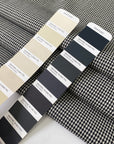 Pure wool with a pied de poule design in the shades of antique white and black sand. Stiff and rough, ideal for coats, jackets, and structured skirts. High-quality deadstock collected in Stock from a Maison de Couture in Italy.