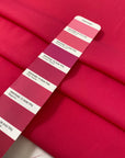 Fluorescent fuchsia polyester crêpe de chine with a fluid drape and matte texture ideal for bold blouses dresses and linings. High-quality deadstock collected in Stock from a Maison de Couture in Italy.