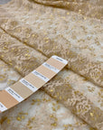 Polyester lace in floral design stretch, very soft and light. Skin ground color with some gold lurex. High-quality deadstock fabric collected in Stock from a Maison de Couture in Italy.