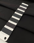 Very soft and flowing polyester georgette in a dark gray shade, color reference Meteorite. Ideal for dresses, skirts, blouses, and shirting. High-quality deadstock collected in Stock from a Maison de Couture in Italy.