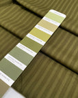 Pure cotton jacquard in avocado green with refined stripe design. Versatile and elegant, ideal for dresses, skirts, and trousers. High-quality deadstock collected in Stock from a Maison de Couture in Italy.