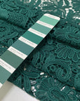 Light and soft polyester macro lace in dark green with a double scallop edge and baroque floral design. Perfect for dresses, skirts, and blouses.High-quality deadstock collected in Stock from a Maison de Couture in Italy.