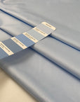 Light blue polyester fabric with a shiny effect, soft and slightly crunchy texture ideal for delicate details and overlays. High-quality deadstock collected in Stock from a Maison de Couture in Italy.