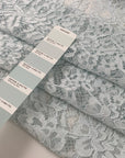 Polyester rebrodé lace in light blue very soft and light. Transparent with double scalloped. High-quality deadstock fabric by the meter collected in Stock from a Maison de Couture in Italy