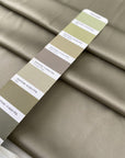 Polyester satin in sage green color reference elm. Very soft, light, and flowy with a matte finish. Not transparent. Ideal for dresses, skirts, and shirting. High-quality deadstock collected in Stock from a Maison de Couture in Italy.