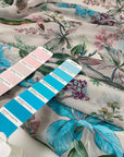 Polyester chiffon printed with floral and leaf design in shades of pink, green, and light blue. Very light, flowy, and transparent. High-quality deadstock collected in Stock from a Maison de Couture in Italy.