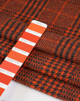 Prince of Wales knit of pure orange wool. The fabric is soft and strecthy. High quality deadstock fabric.