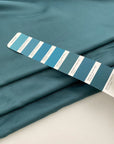 Soft and droopy silk twill in Persian green. High quality deadstock fabric.