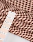 Pink stretch cotton blend summer tweed with black threads. High quality deadstock fabric.