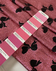 Silk and lurex fabric in pink with black bow print. Very soft and light, flowy and sparkling, not transparent. Ideal for dresses, skirts, blouses, and shirting. High-quality deadstock collected in Stock from a Maison de Couture in Italy.