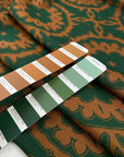 Heavy polyester elastane Punto Milano jersey with a beautiful paisley design in the shade forest green and leather brown. Ideal for structured dresses and tops. High-quality deadstock collected in Stock from a Maison de Couture in Italy.