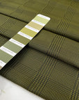 Soft tafta in polyester in olive green with prince of Wales design. High-quality deadstock fabric collected in Stock from a Maison de Couture in Italy.