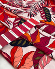 Printed viscose with tropical flower design in white, fuchsia, orange, and red shades. Very soft, light, and flowy. High-quality deadstock fabric by the meter collected in Stock from a Maison de Couture in Italy.