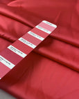 Polyester satin in coral, color reference Paradise Pink. Very soft, light and shiny, not transparent. Ideal for shirting, blouses, dresses and skirts. High-quality deadstock collected in Stock from a Maison de Couture in Italy.
