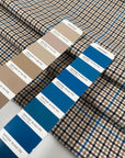 Mixed polyester comfort stretch, with checked design in the shades of beige, color reference natural, and turquoise, color reference fiod blue. A little heavy and flowy, ideal for trousers and jackets. High-quality deadstock collected in Stock from a Maison de Couture in Italy.