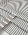 Pure cotton popeline, very light with cruncy and stiff texture. Gray and white stripes. High-quality deadstock fabric by the meter collected in Stock from a Maison de Couture in Italy.
