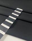 Black microfiber in polyester stretch, color reference tap shoe. A little bit crunchy and light, ideal for jackets, trenches, and trousers. High-quality deadstock collected in Stock from a Maison de Couture in Italy.