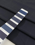 Wool mixed with polyester and elastane featuring a check design in dark blue. Very soft, light, flowy, and not transparent. Ideal for trousers, skirts, and jackets. High-quality deadstock collected in Stock from a Maison de Couture in Italy.