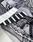 Polyester microtulle jersey very stretchy, soft, light, and transparent. With a geometrical design in white and black shades. High-quality deadstock fabric by the meter collected in Stock from a Maison de Couture in Italy.