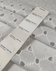 White cotton Sangallo lace with delicate embroidered eyelets and soft, breathable texture ideal for blouses dresses and summerwear. High-quality deadstock collected in Stock from a Maison de Couture in Italy.
