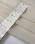 Pure wool muslin in light vanilla color reference Winter White. Very soft, light, and warm, with slight transparency. Flowy and ideal for scarves, light shirting, and dresses. High-quality deadstock collected in Stock from a Maison de Couture in Italy.