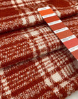 Soft checkered mixed wool tweed in orange and white. High quality deadstock fabric.