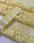 Polyester lace in limelight yellow with double scallop. Light and decorative, ideal for dresses, blouses, and skirts. High-quality deadstock collected in Stock from a Maison de Couture in Italy.