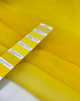 Bright yellow polyester organza transparent and light. High-quality deadstock fabric collected in Stock from a Maison de Couture in Italy.
