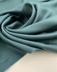 Soft and droopy silk twill in Persian green. High quality deadstock fabric.