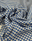 Mixed cotton tweed with a white ground and blue pied de poule pattern, color reference Victoria Blue. Very soft, light, flowy, and not transparent. Ideal for dresses, trousers, skirts, and jackets. High-quality deadstock collected in Stock from a Maison de Couture in Italy.