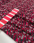 Viscose and wool with a beautiful small flower design, the ground is raspberry and the flowers are in green, white, gray, and black shades. It is very soft, light and warm. High-quality deadstock fabric by the meter collected in Stock from a Maison de Couture in Italy.