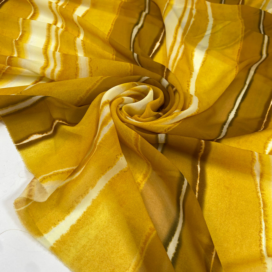 Polyester chiffon with tie-dye print in the shades of yellow mimosa. Very soft, light, transparent, and flowy. Ideal for skirts, blouses, and dresses. | Pantone 14-0848 TPG