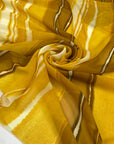 Polyester chiffon with tie-dye print in the shades of yellow mimosa. Very soft, light, transparent, and flowy. Ideal for skirts, blouses, and dresses. | Pantone 14-0848 TPG