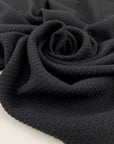 Black mesh fabric in a blend of cotton, polyester, and elastane with a textured surface, soft, breathable, and slightly stretchy. Ideal for inserts, layering, and sporty pieces. High-quality deadstock collected in Stock from a Maison de Couture in Italy.