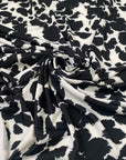 Printed polyester jersey with black spots on a white base soft and fluid ideal for tops dresses and layering pieces. High-quality deadstock collected in Stock from a Maison de Couture in Italy.