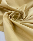 Cotton polyester fabric in pale banana yellow, very crunchy, light, and not transparent, ideal for shirts, dresses, and structured pieces. High-quality deadstock collected in Stock from a Maison de Couture in Italy.