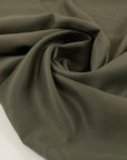 Very soft and flowy viscose/polyester cady in dark olive green, double face and not transparent. High-quality deadstock collected in Stock from a Maison de Couture in Italy.