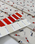 Very soft and light polyester satin with ivory ground and small fantasy design of birds and lighthouses. Not transparent. High-quality deadstock collected in Stock from a Maison de Couture in Italy.