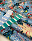 Polyester satin with floral design in the shades of blue, white, light blue, green and red. Very soft, light and flowy. High-quality deadstock fabric collected in Stock from a Maison de Couture in Italy.