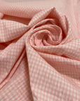 Cotton and polyester blend with stretch in a white and pink checked seersucker texture. Soft and fresh, ideal for dresses, skirts, trousers, and blouses.High-quality deadstock collected in Stock from a Maison de Couture in Italy.