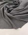 Gray jersey of viscose Punto Milano printed Prince of Wales. High-quality deadstock fabric collected in Stock from a Maison de Couture in Italy.