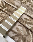 Stiff viscose and polyester taffeta printed with a jungle leaf design in sand and beige shades. Adds volume and holds shape, ideal for skirts, trench coats, and dresses. High-quality deadstock collected in Stock from a Maison de Couture in Italy.